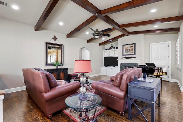 living room featuring dark wood-type flooring, ceiling fan, plenty of natural light, and lofted ceiling with beams