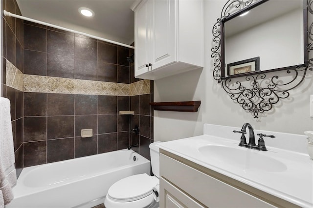 full bathroom with vanity, tiled shower / bath, and toilet