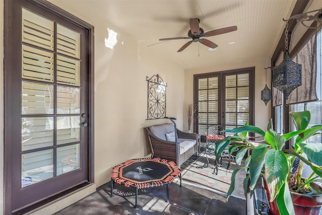 sunroom / solarium featuring ceiling fan and french doors