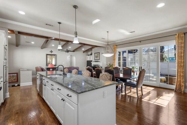 kitchen with white cabinetry, an island with sink, appliances with stainless steel finishes, and sink