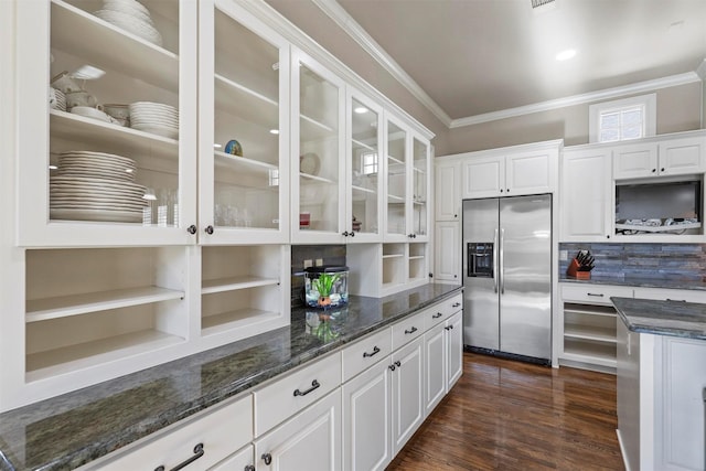 kitchen with dark hardwood / wood-style flooring, white cabinets, dark stone counters, and stainless steel fridge with ice dispenser