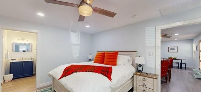 bedroom featuring connected bathroom, ceiling fan, and light hardwood / wood-style floors