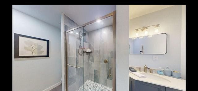 bathroom featuring vanity and an enclosed shower