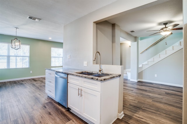 kitchen featuring sink, dark wood-type flooring, dishwasher, white cabinetry, and dark stone countertops