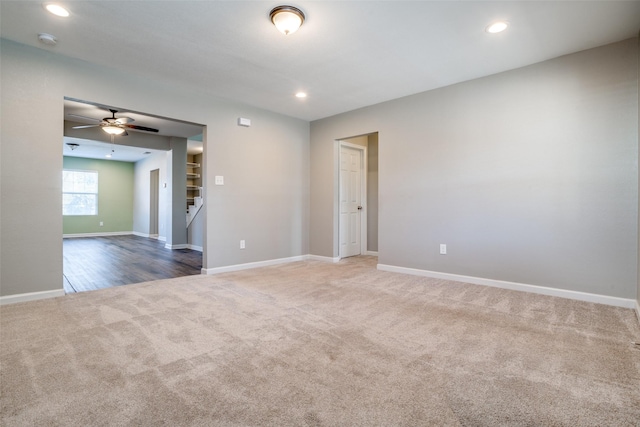 unfurnished room with carpet and ceiling fan