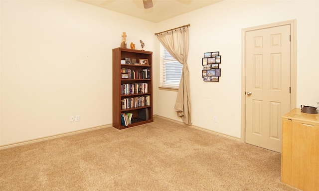 carpeted empty room featuring ceiling fan