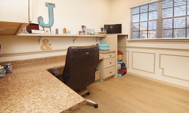 home office with light hardwood / wood-style floors