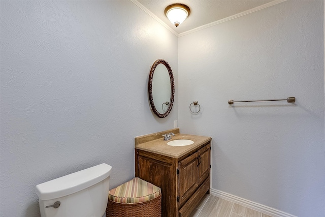 bathroom featuring crown molding, vanity, and toilet