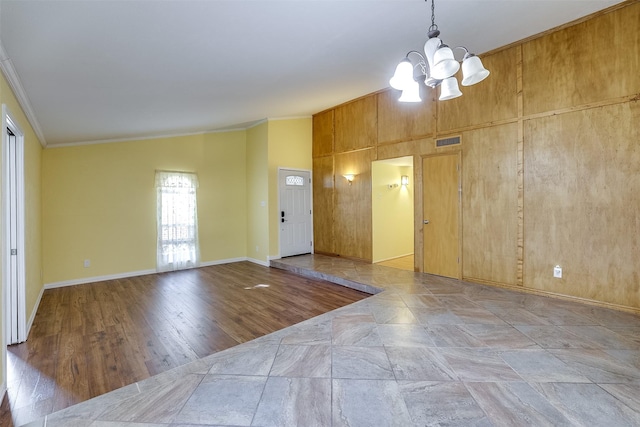 interior space featuring crown molding, vaulted ceiling, and a chandelier