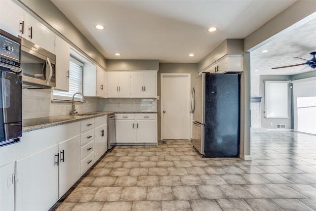 kitchen with white cabinets, sink, and black appliances