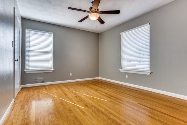 spare room with ceiling fan and light wood-type flooring