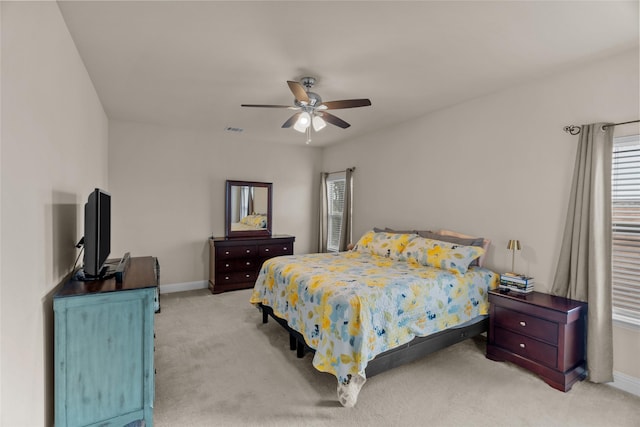 bedroom with ceiling fan and light carpet