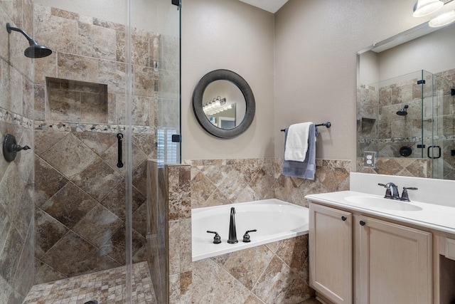 bathroom featuring vanity and shower with separate bathtub