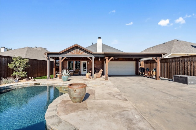 exterior space with a fenced in pool and a patio