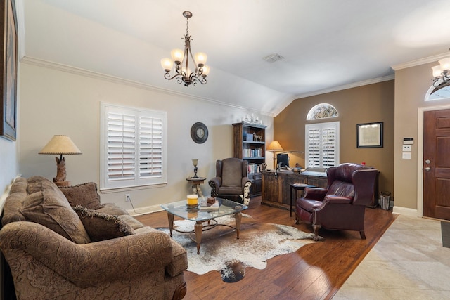 living room with ornamental molding, lofted ceiling, an inviting chandelier, and light hardwood / wood-style floors