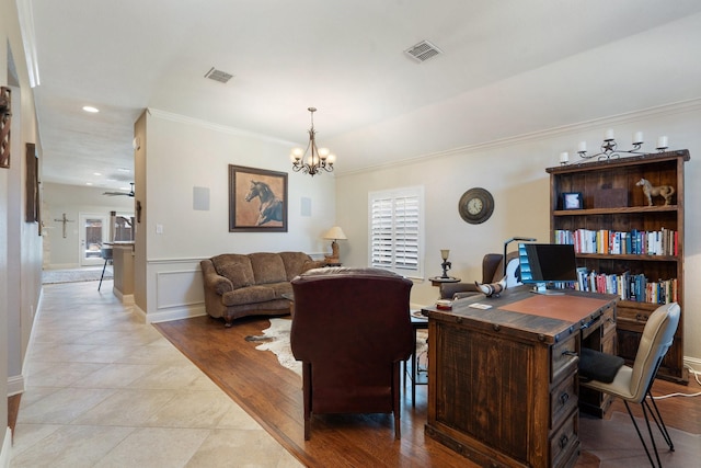 tiled office space featuring crown molding and a chandelier