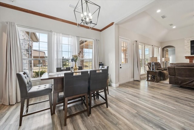 dining space with baseboards, light wood-style floors, a chandelier, and a wealth of natural light