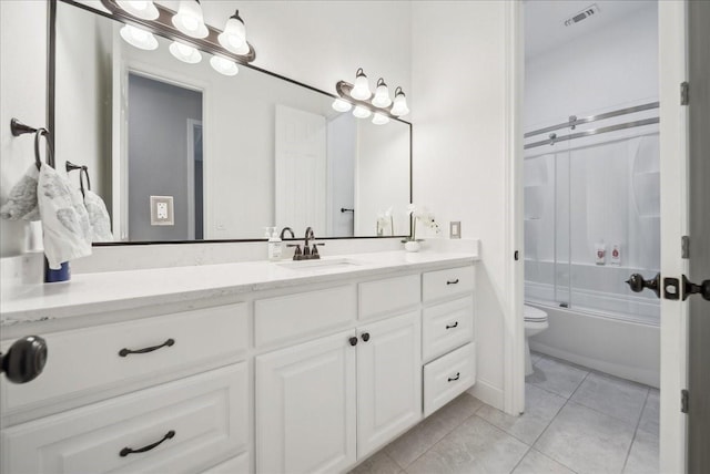 full bath with tile patterned flooring, vanity, toilet, visible vents, and bath / shower combo with glass door
