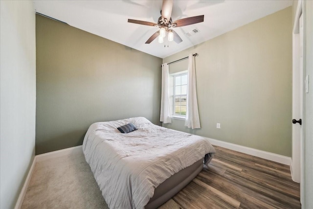 bedroom with ceiling fan and wood-type flooring