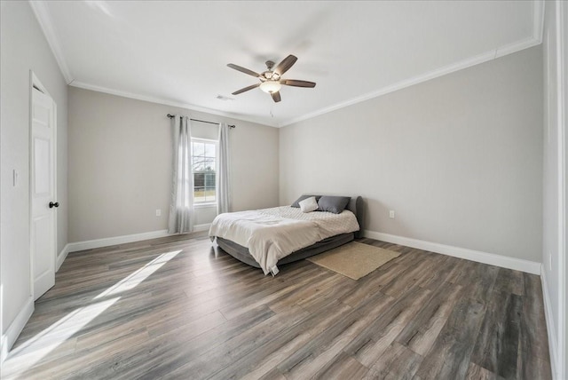 bedroom featuring ornamental molding, dark hardwood / wood-style floors, and ceiling fan