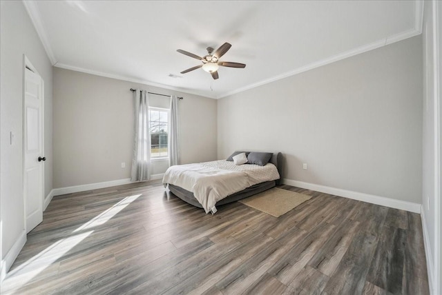 bedroom with crown molding, baseboards, a ceiling fan, and wood finished floors