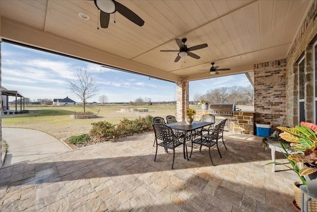 view of patio / terrace with exterior kitchen and a grill