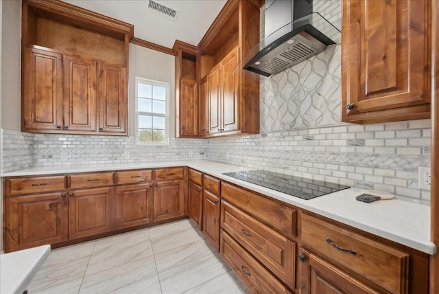 kitchen with visible vents, ornamental molding, brown cabinetry, wall chimney range hood, and black electric cooktop