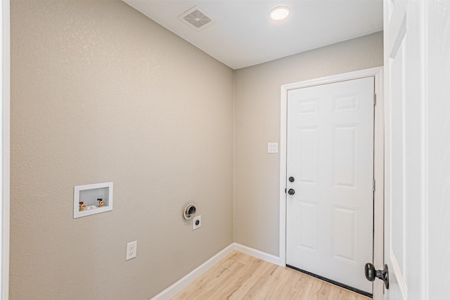 washroom with hookup for a washing machine, light hardwood / wood-style floors, and electric dryer hookup