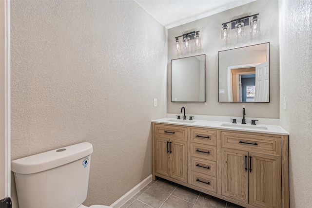 bathroom featuring tile patterned floors, toilet, and vanity