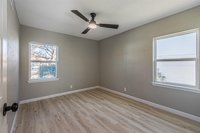 empty room featuring ceiling fan and light hardwood / wood-style flooring