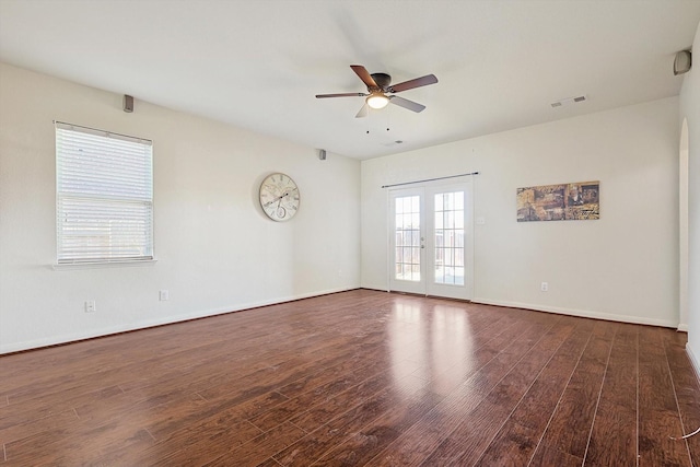 unfurnished room featuring dark hardwood / wood-style floors, ceiling fan, and french doors