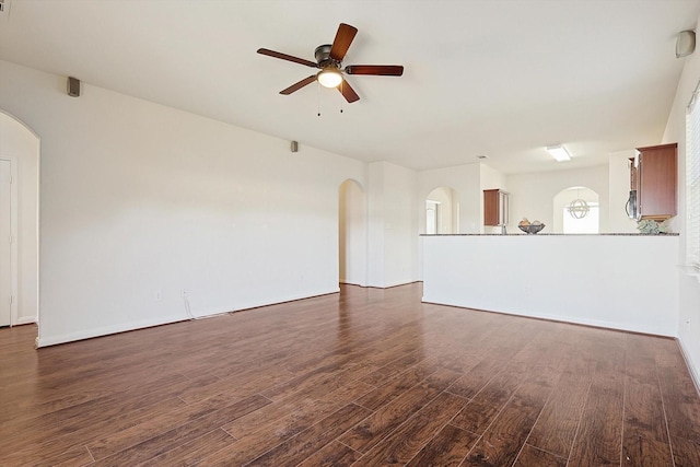 unfurnished living room featuring dark hardwood / wood-style floors and ceiling fan