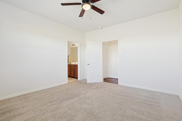 spare room featuring light carpet and ceiling fan