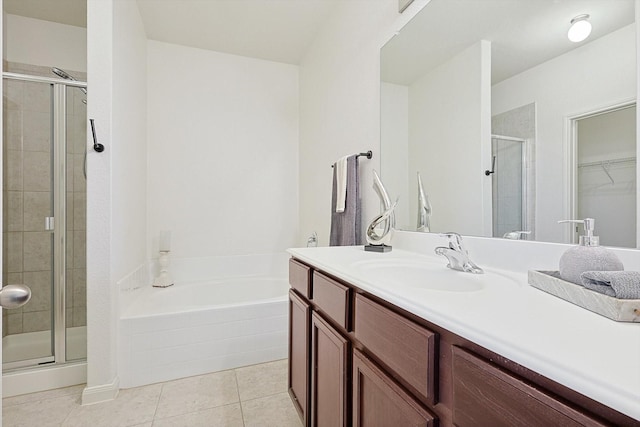 bathroom featuring independent shower and bath, vanity, and tile patterned floors