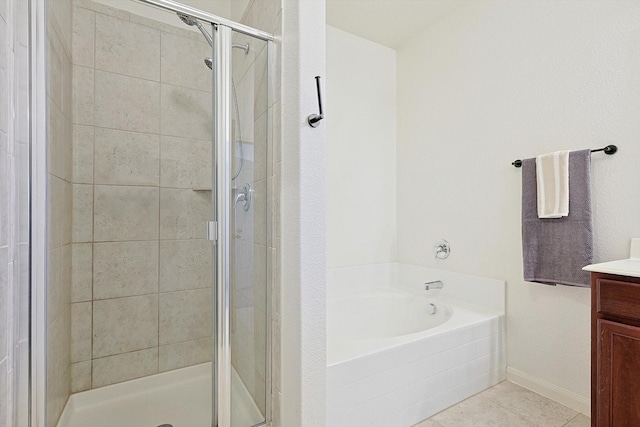 bathroom with tile patterned flooring, vanity, and plus walk in shower