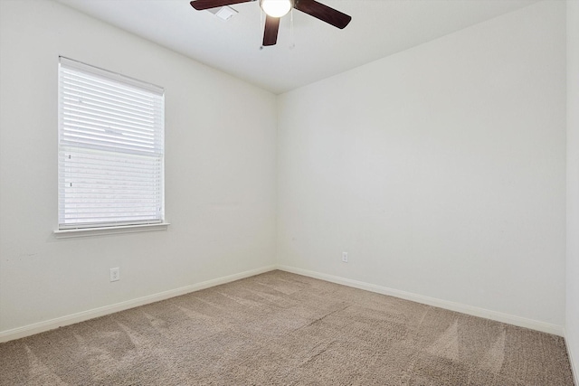 carpeted empty room featuring ceiling fan