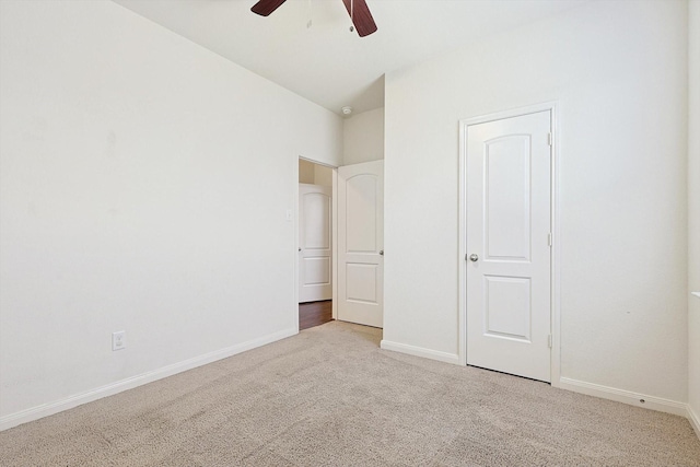 unfurnished bedroom with ceiling fan and light colored carpet