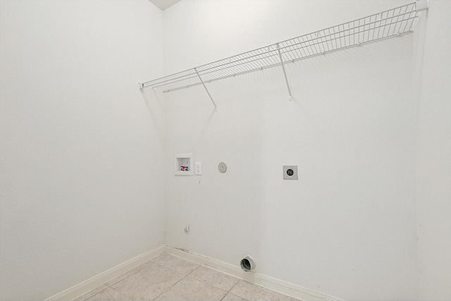 laundry area featuring gas dryer hookup, washer hookup, hookup for an electric dryer, and light tile patterned floors