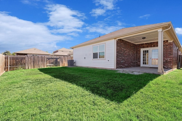 back of house featuring a yard, a patio, central air condition unit, and french doors