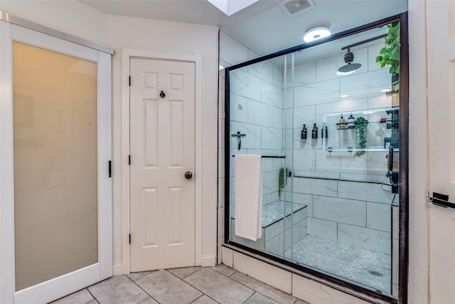 bathroom with tile patterned flooring and an enclosed shower