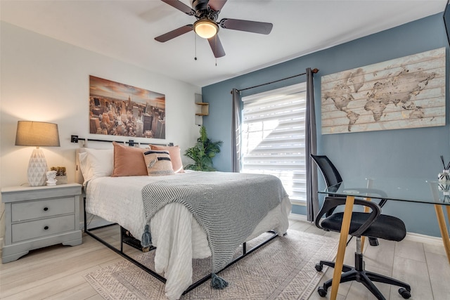 bedroom with ceiling fan and light wood-type flooring