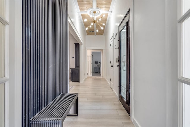 hall featuring a notable chandelier, light hardwood / wood-style flooring, and wooden ceiling