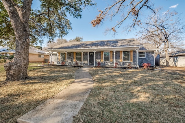 ranch-style home with a porch and a front yard