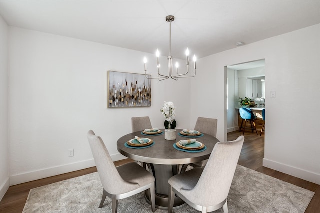 dining room featuring a notable chandelier and dark wood-type flooring