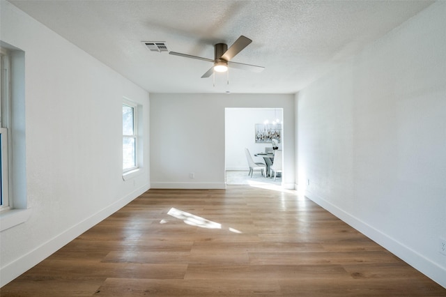 unfurnished room with hardwood / wood-style flooring, a textured ceiling, and ceiling fan