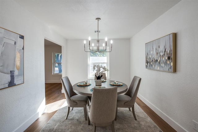 dining room featuring dark hardwood / wood-style flooring and a chandelier