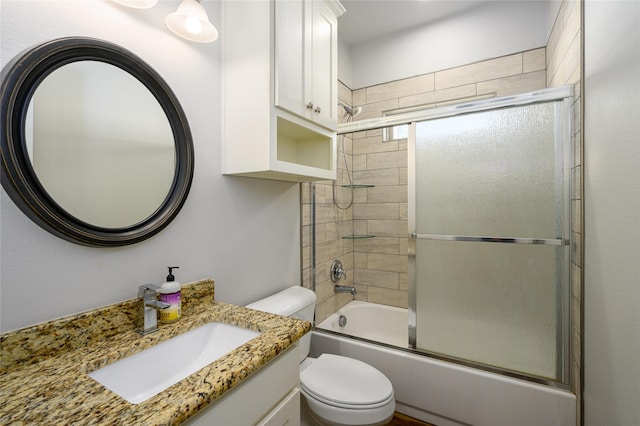 full bathroom with vanity, combined bath / shower with glass door, and toilet