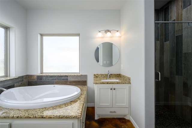 bathroom with vanity and shower with separate bathtub