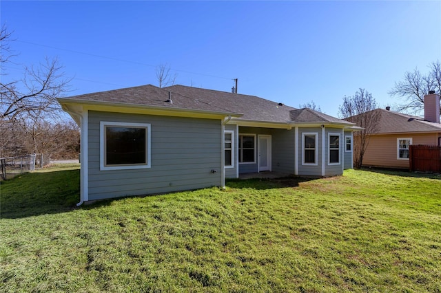 rear view of property with a yard