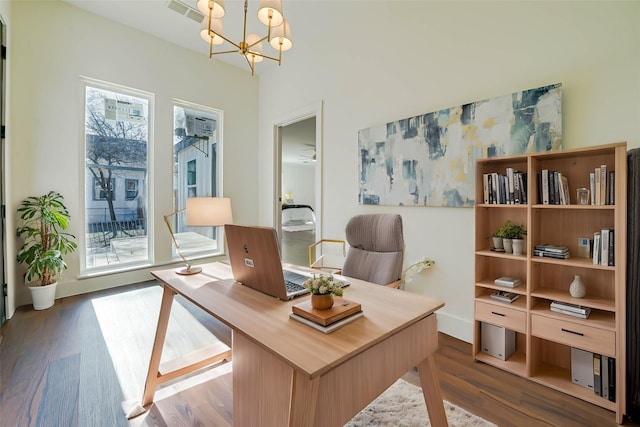 office area featuring an inviting chandelier, plenty of natural light, visible vents, and wood finished floors